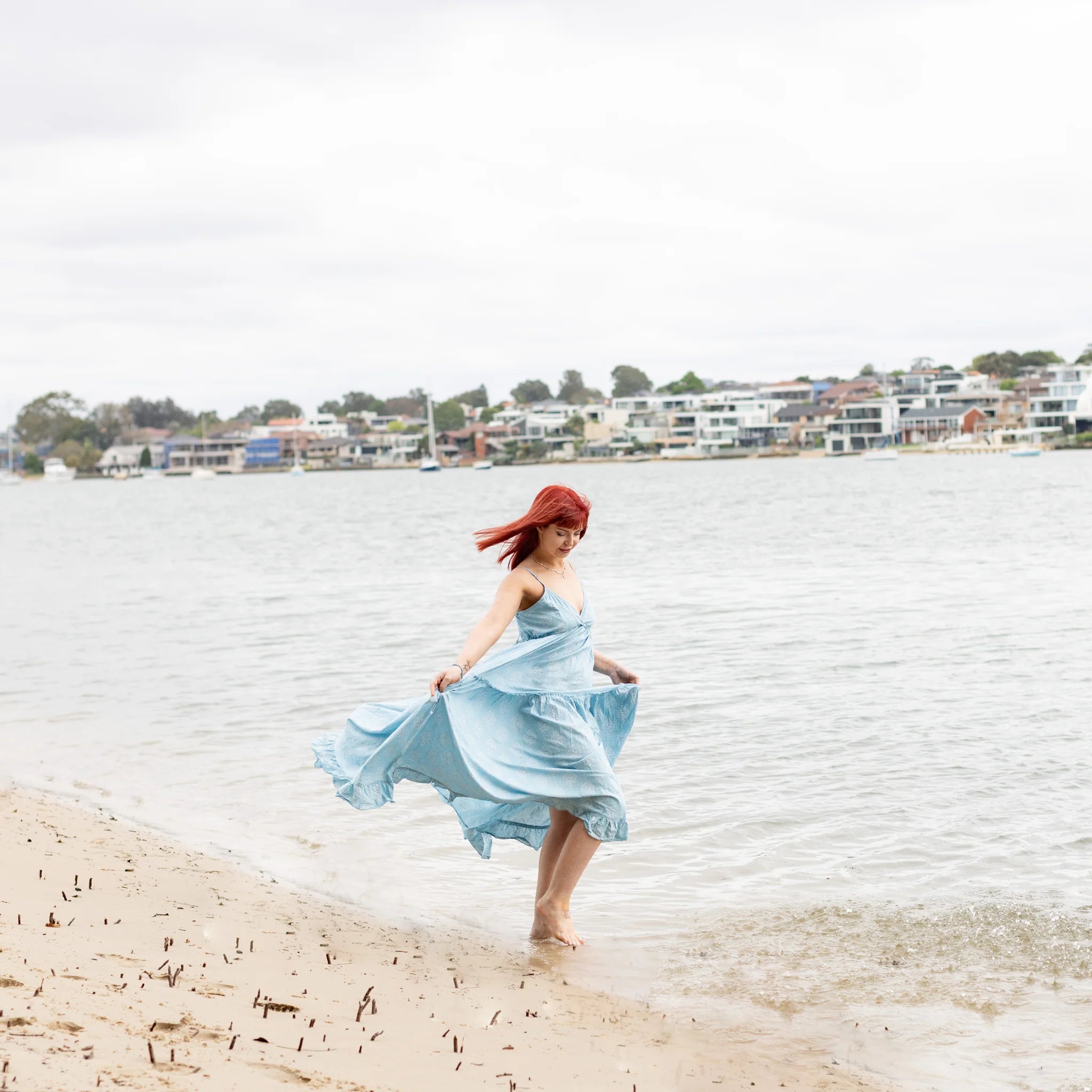 Intuitive Charms model dancing on beach with apatite bracelet