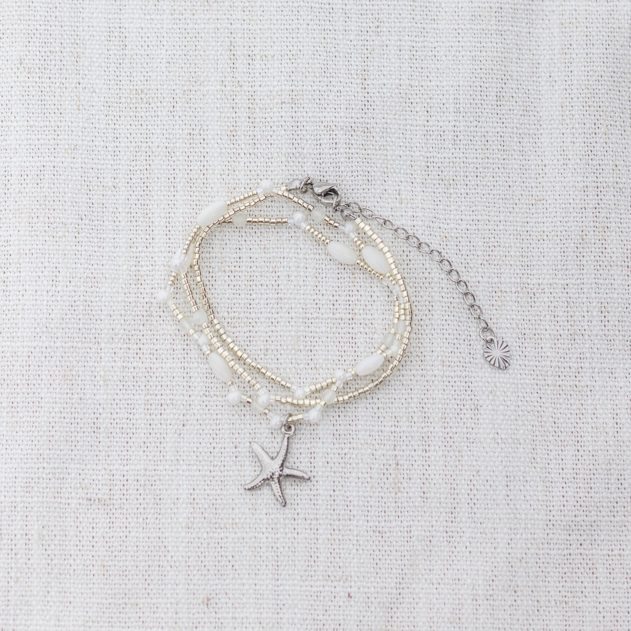 Intuitive Charms Selene's Song Moonstone natural Crystal beaded custom necklace in silver and clasp extension on a light fabric background wrapped version