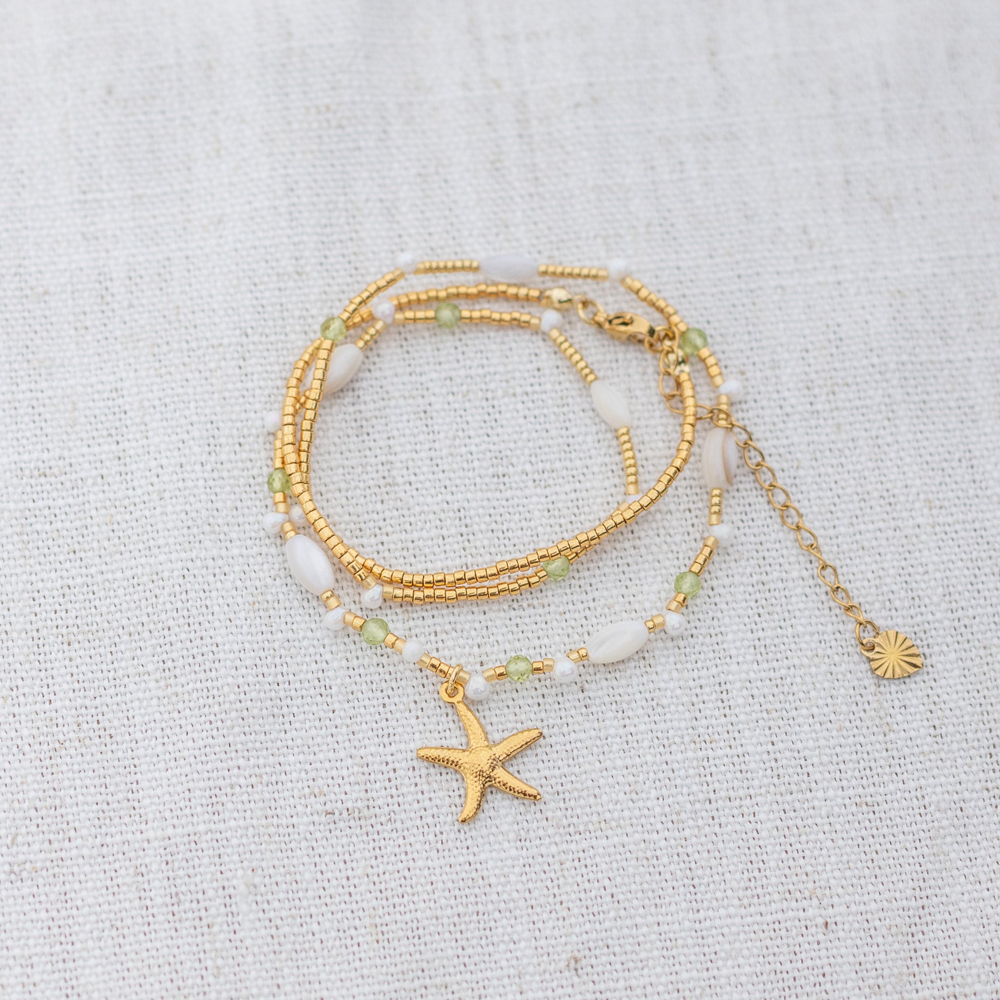 Intuitive Charms Nerina's Song Peridot natural Crystal beaded custom Bracelet in gold on a light fabric background wrapped version