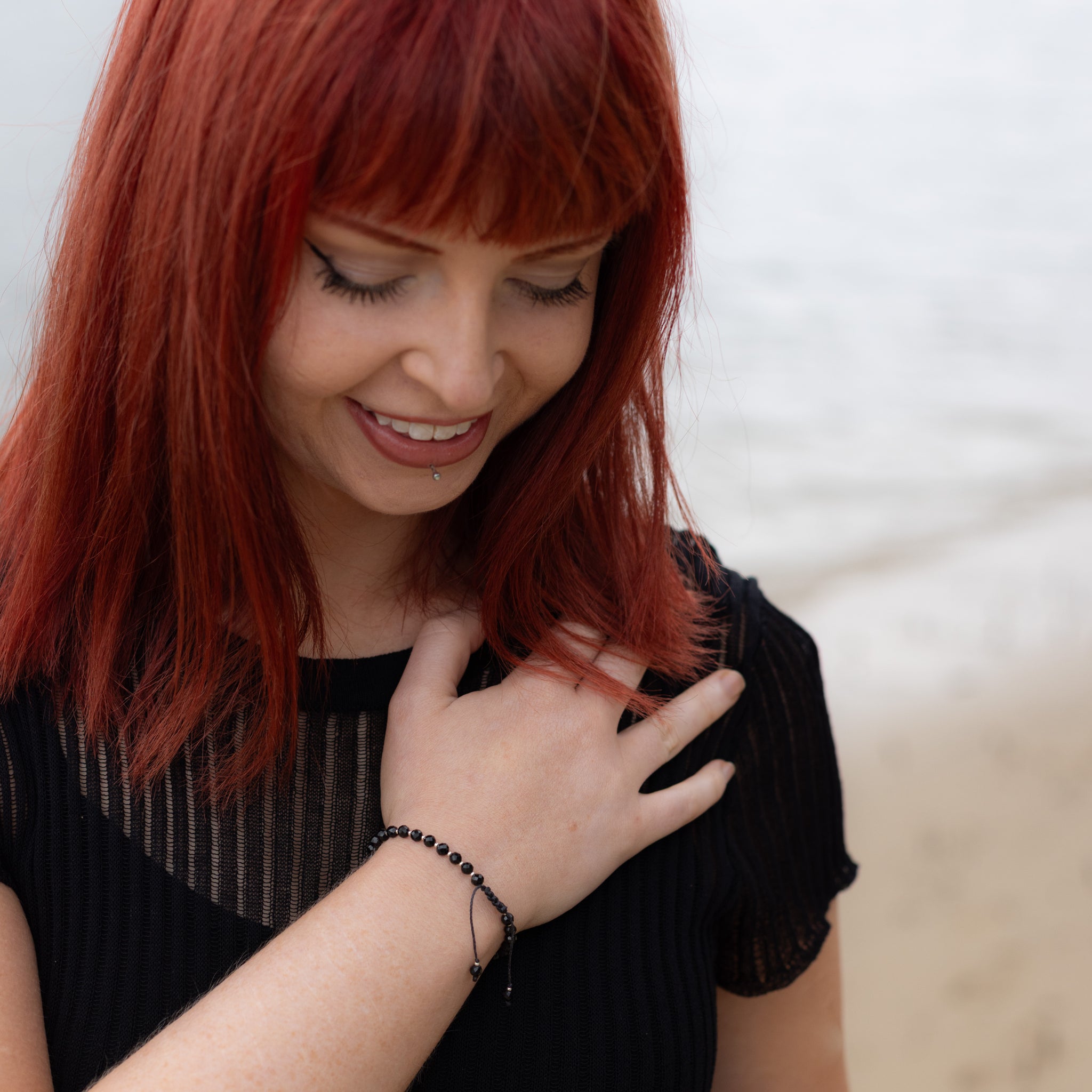 Intuitive Charms Ceto's Glow Apatite Braided natural Crystal beaded custom Bracelet in silver and black cord on a model