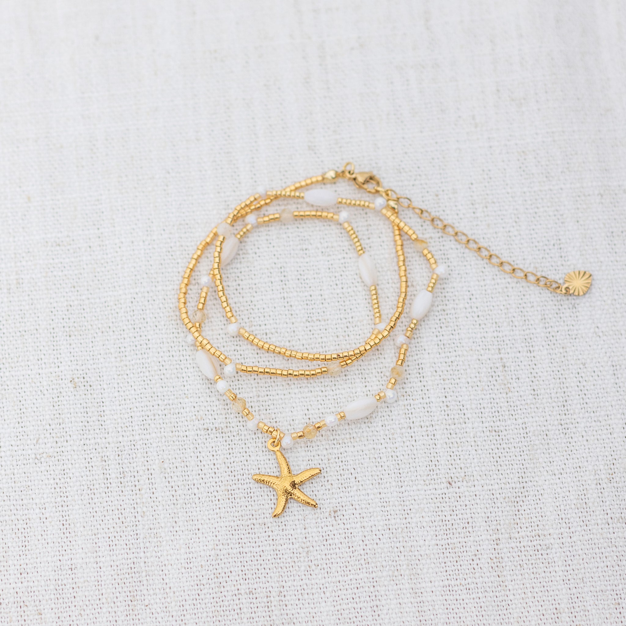 Intuitive Charms Eos's Song Citrine Braided natural Crystal beaded custom Bracelet in gold and clasp extension on a light fabric background wrapped version