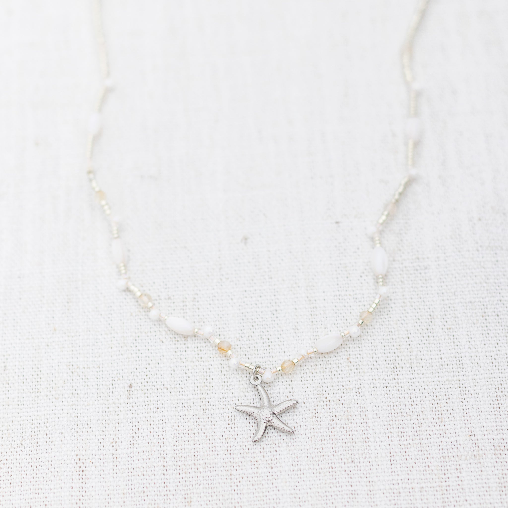 Intuitive Charms Eos's Song Citrine Braided natural Crystal beaded custom Bracelet in silver and clasp extension on a light fabric background