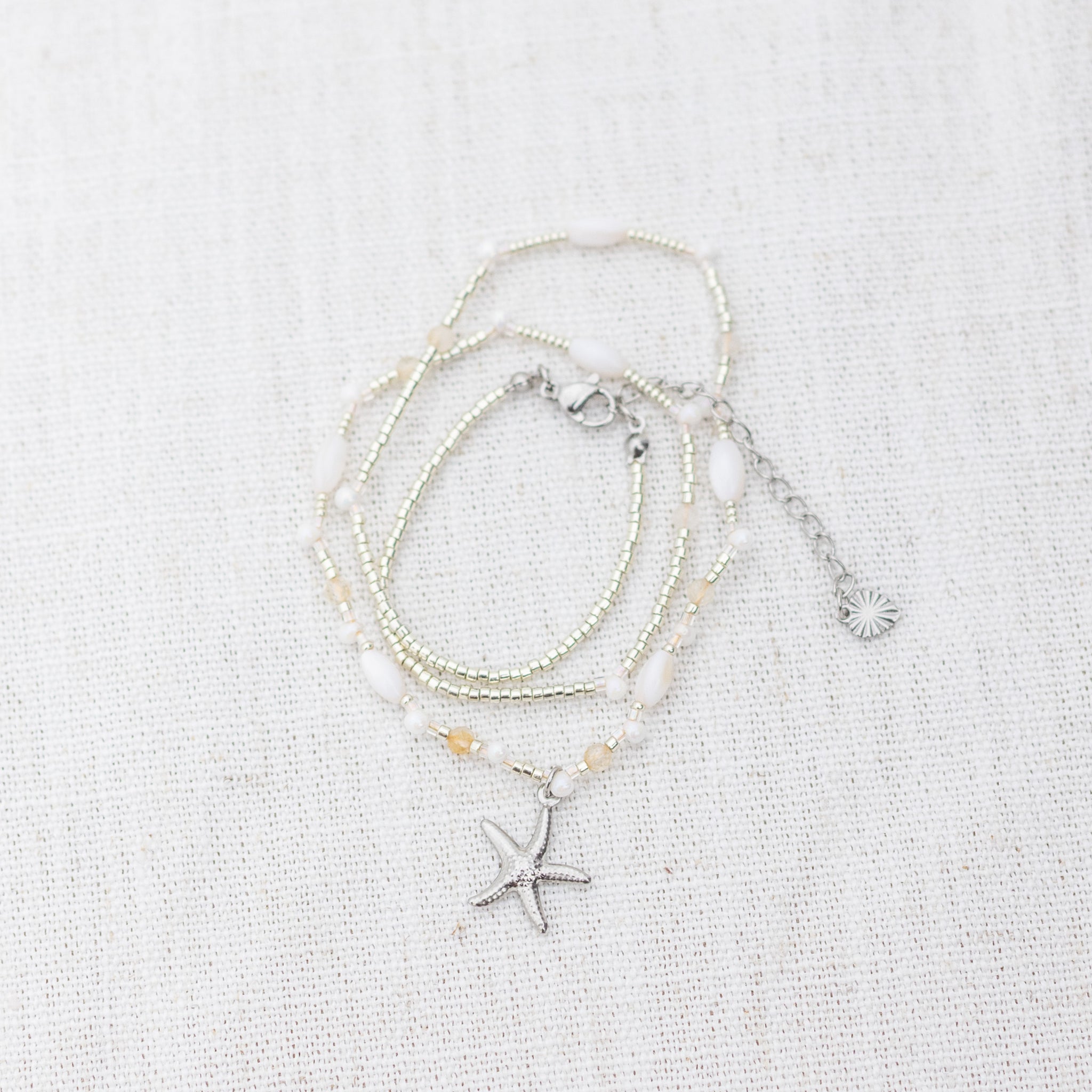 Intuitive Charms Eos's Song Citrine Braided natural Crystal beaded custom Bracelet in silver and clasp extension on a light fabric background wrapped version