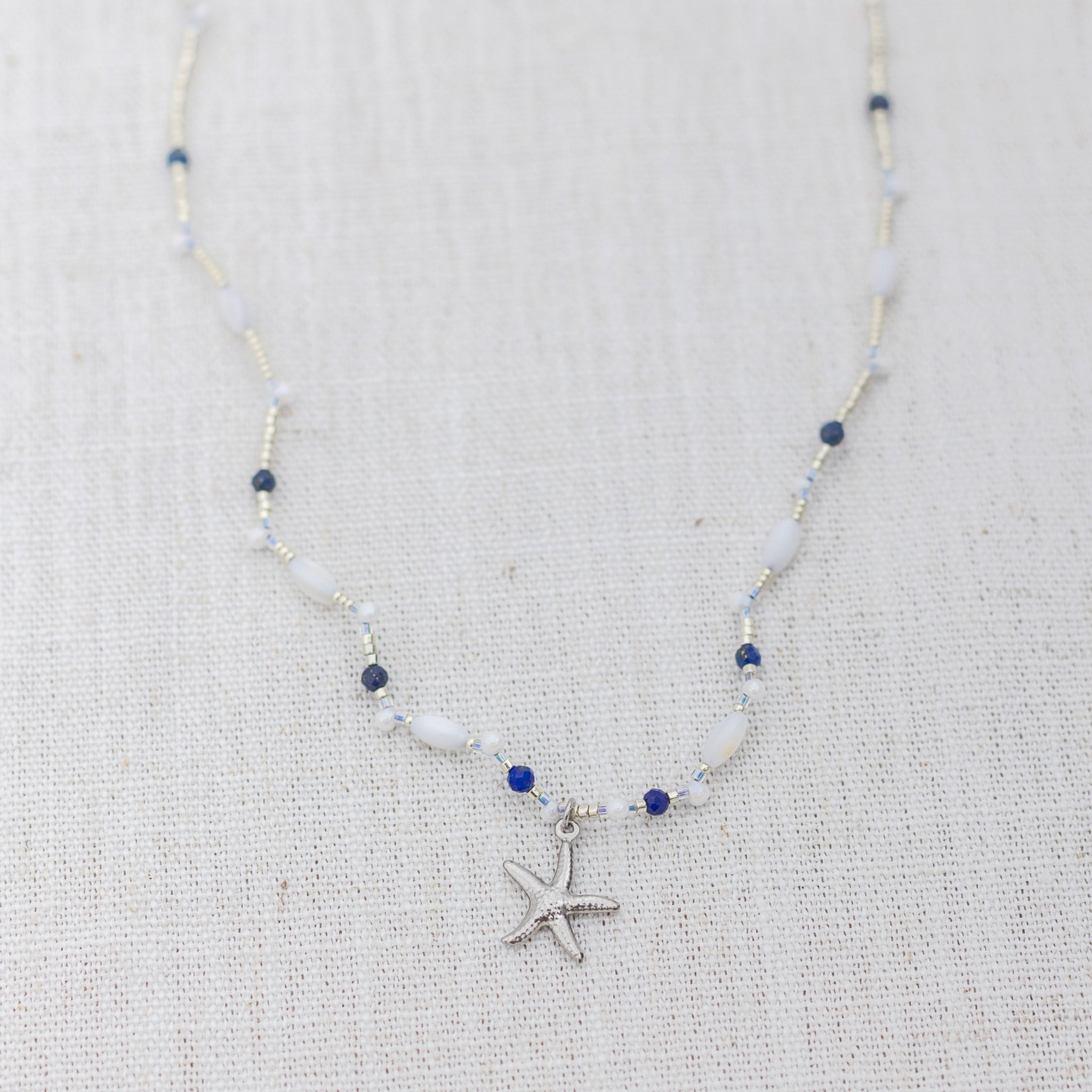 Intuitive Charms Amphitrite's Song Lapis Lazuli Braided natural Crystal beaded custom Bracelet in silver on a light fabric background