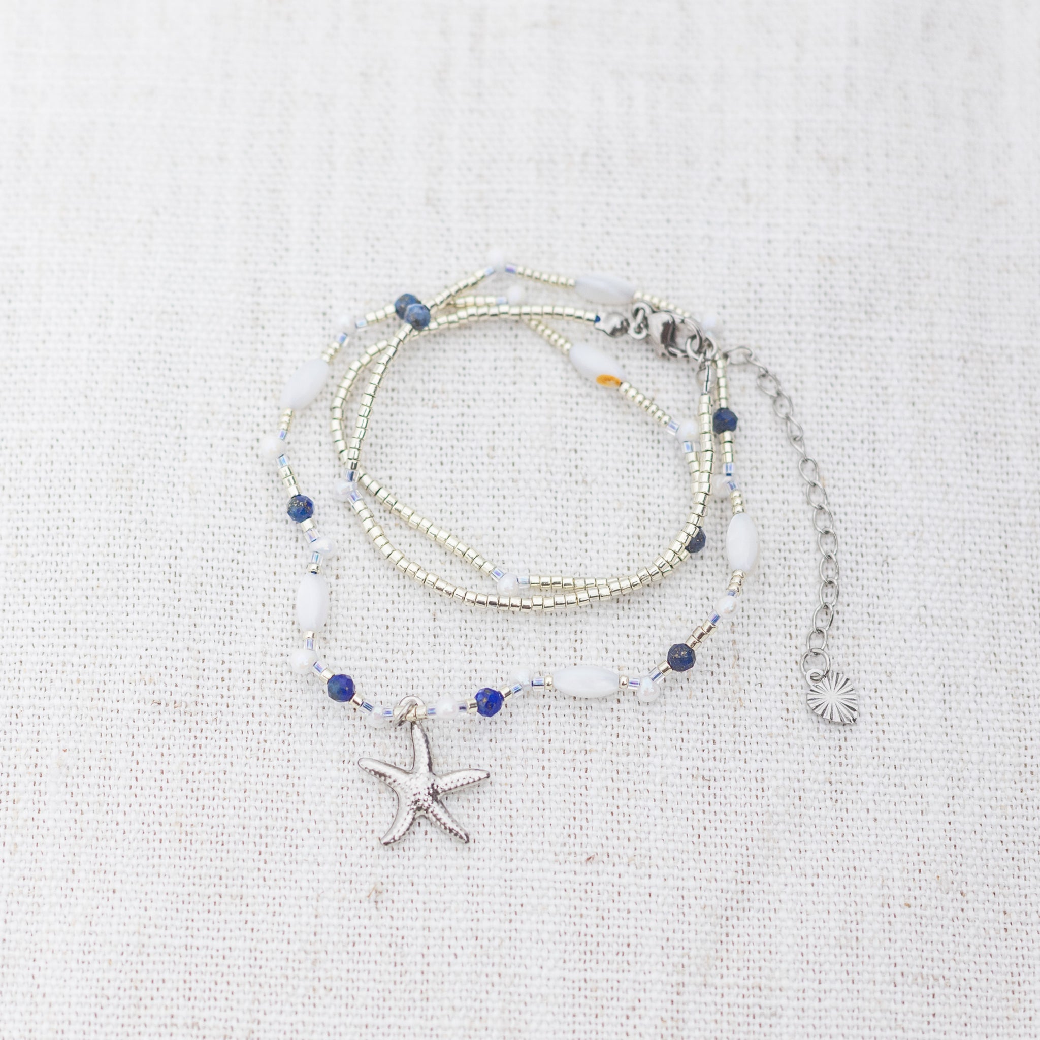 Intuitive Charms Amphitrite's Song Lapis Lazuli Braided natural Crystal beaded custom Bracelet in silver on a light fabric background wrapped version