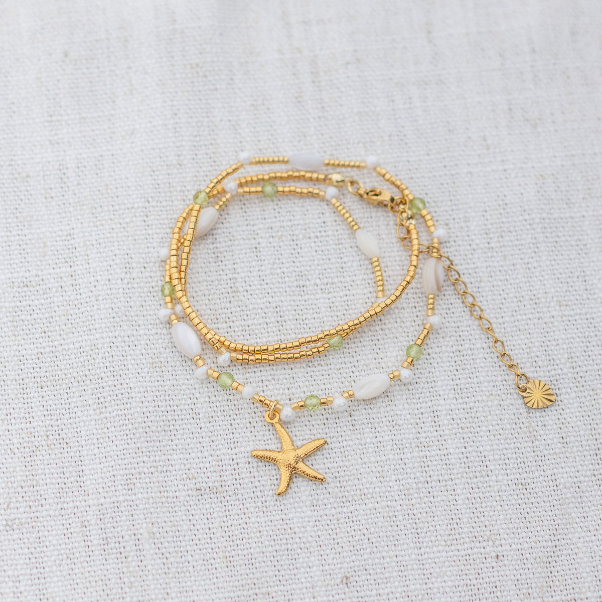 Intuitive Charms Nerina's Song Peridot natural Crystal beaded custom Bracelet in gold on a light fabric background wrapped version