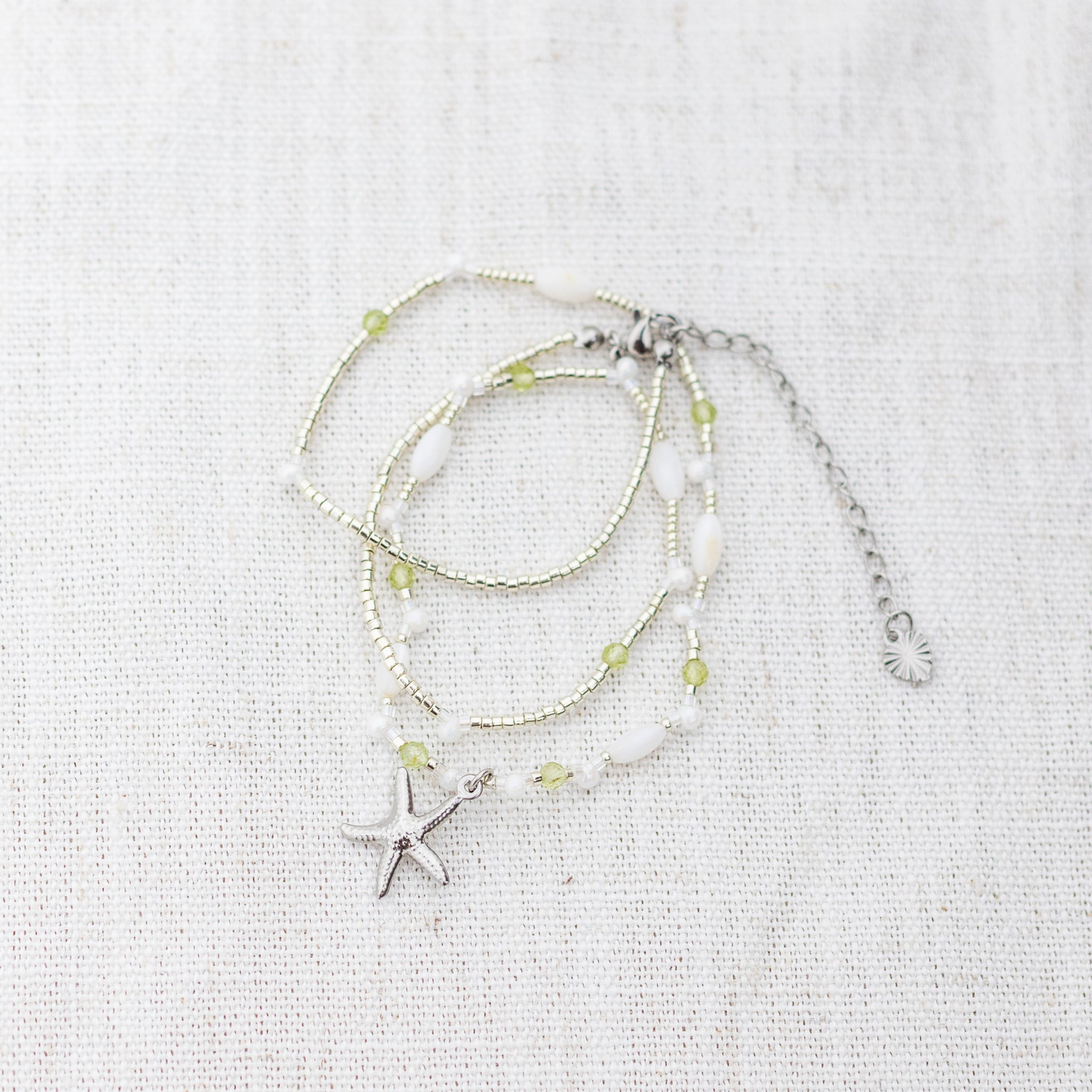 Intuitive Charms Nerina's Song Peridot natural Crystal beaded custom Bracelet in silver on a light fabric background wrapped version
