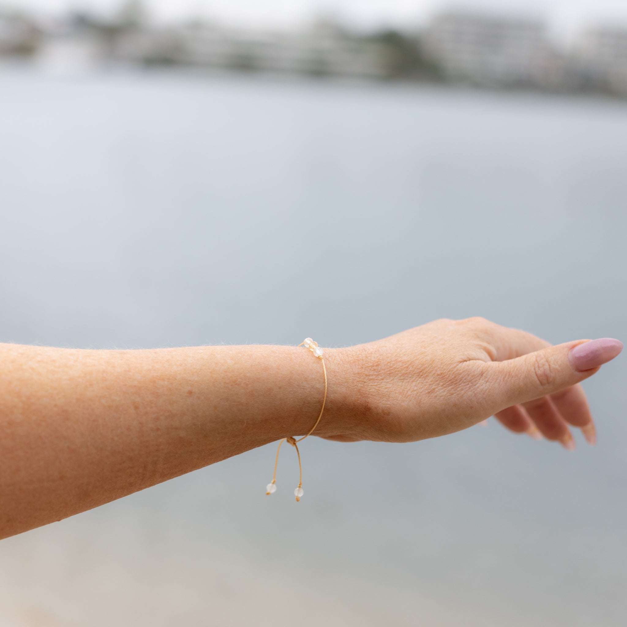 Intuitive Charms Eos's Mist Citrine Braided natural Crystal beaded custom Bracelet in silver and yellow cord on a model hand