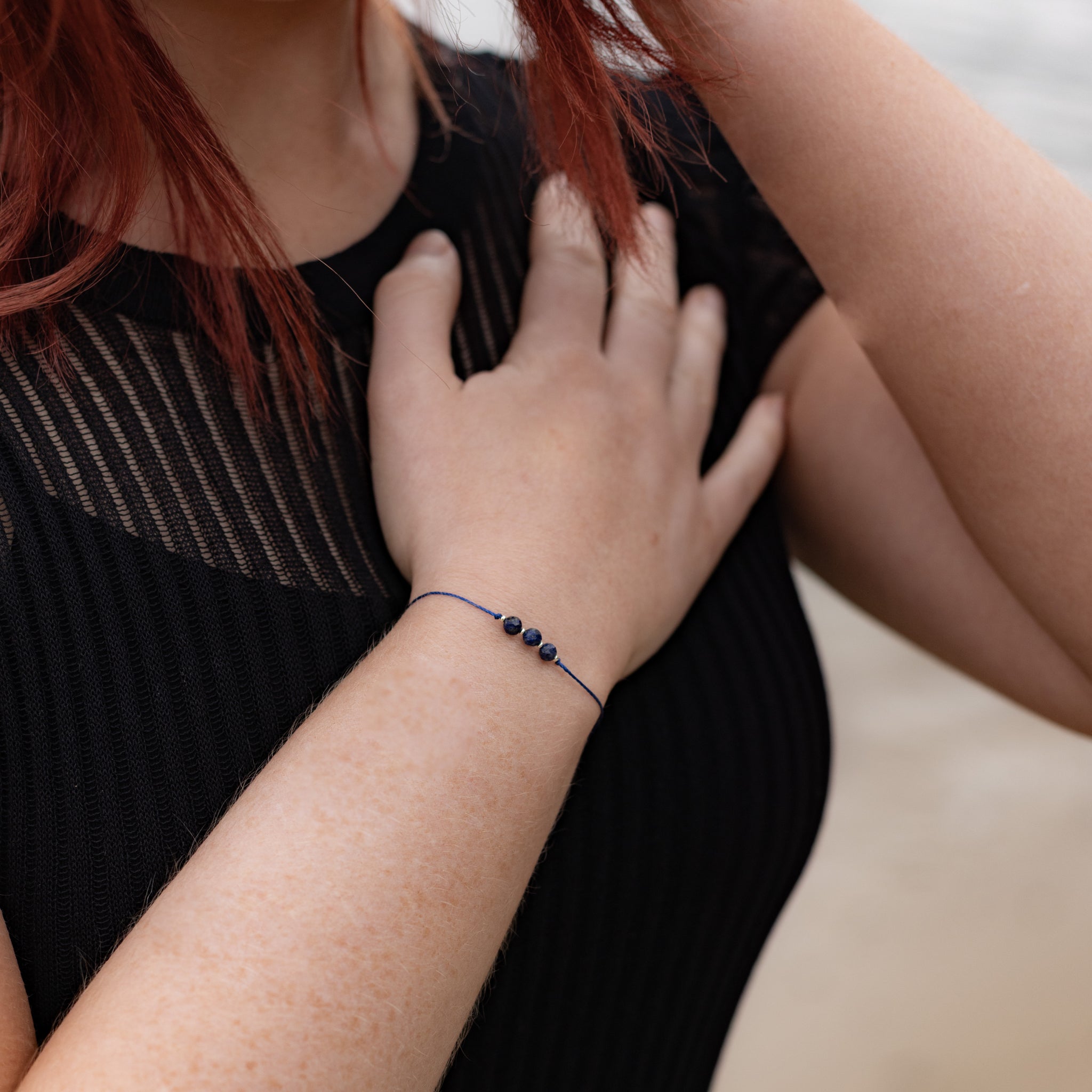 Intuitive Charms Amphitrite's Mist Lapis Lazuli Braided natural Crystal beaded custom Bracelet in silver and deep blue cord on a model