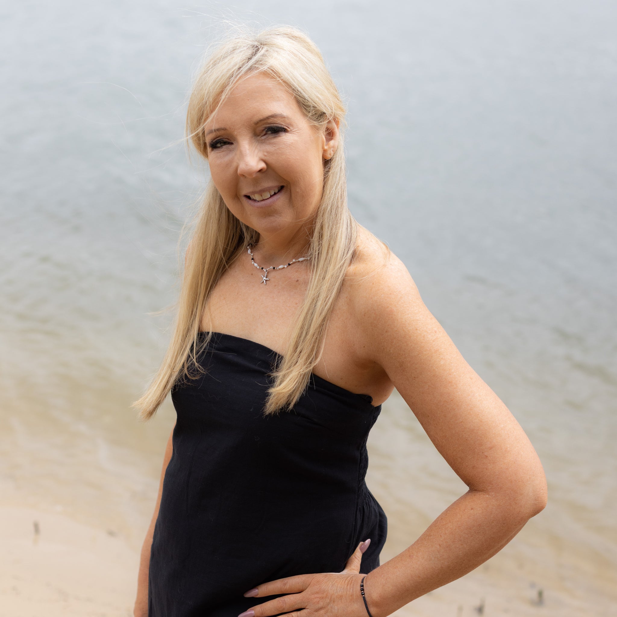 Intuitive Charms Ceto's Song Black tourmaline Braided natural Crystal beaded custom necklace in silver and black cord on a model hands on hip with bracelet