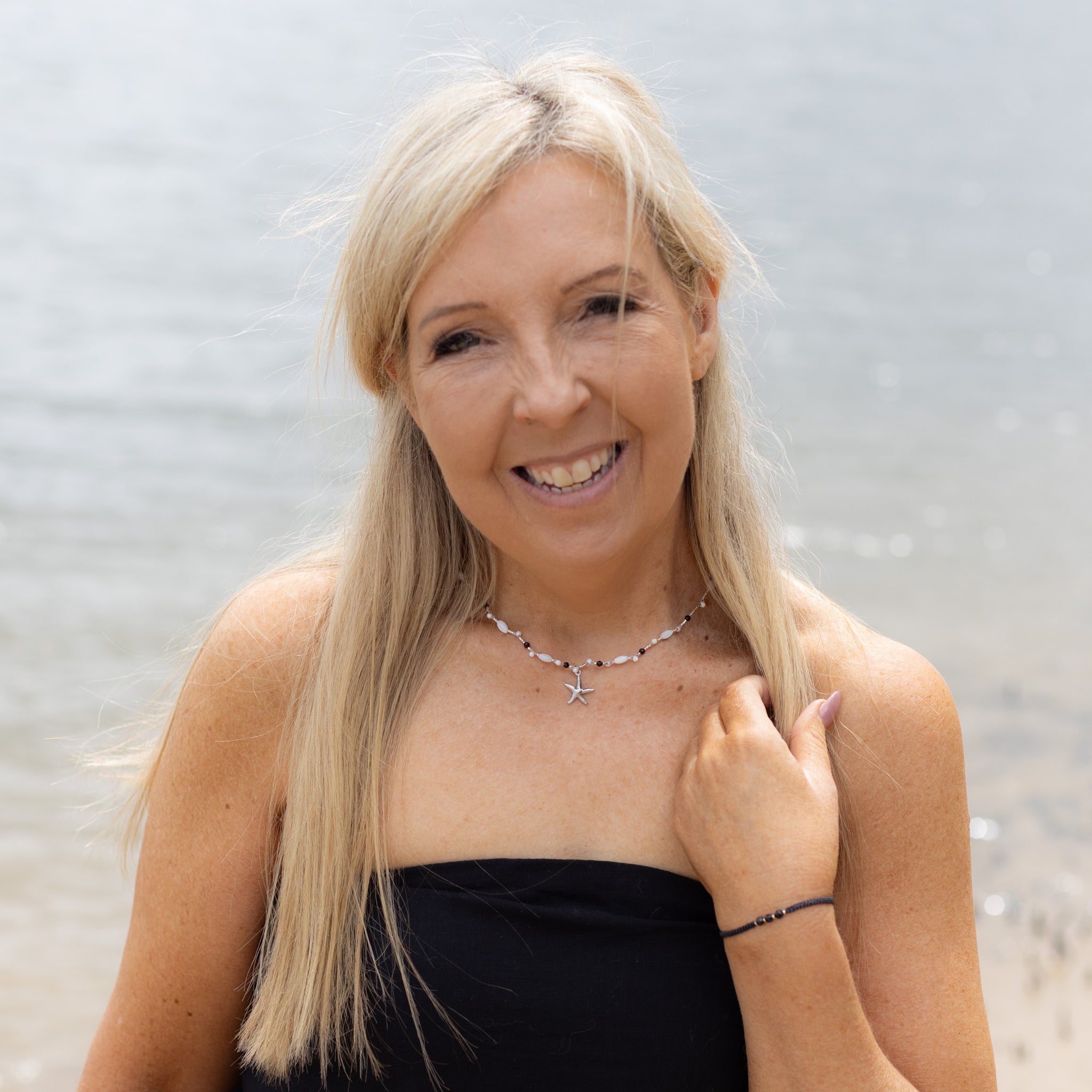 Intuitive Charms Ceto's Song Black tourmaline Braided natural Crystal beaded custom necklace in silver and black cord on a model upper body with bracelet